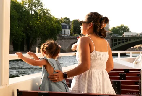 Family with children on a Seine River cruise boat with snacks in Paris